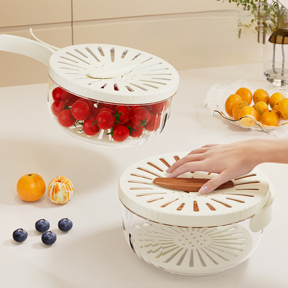 White kitchen colander with tomatoes and oranges on a countertop
