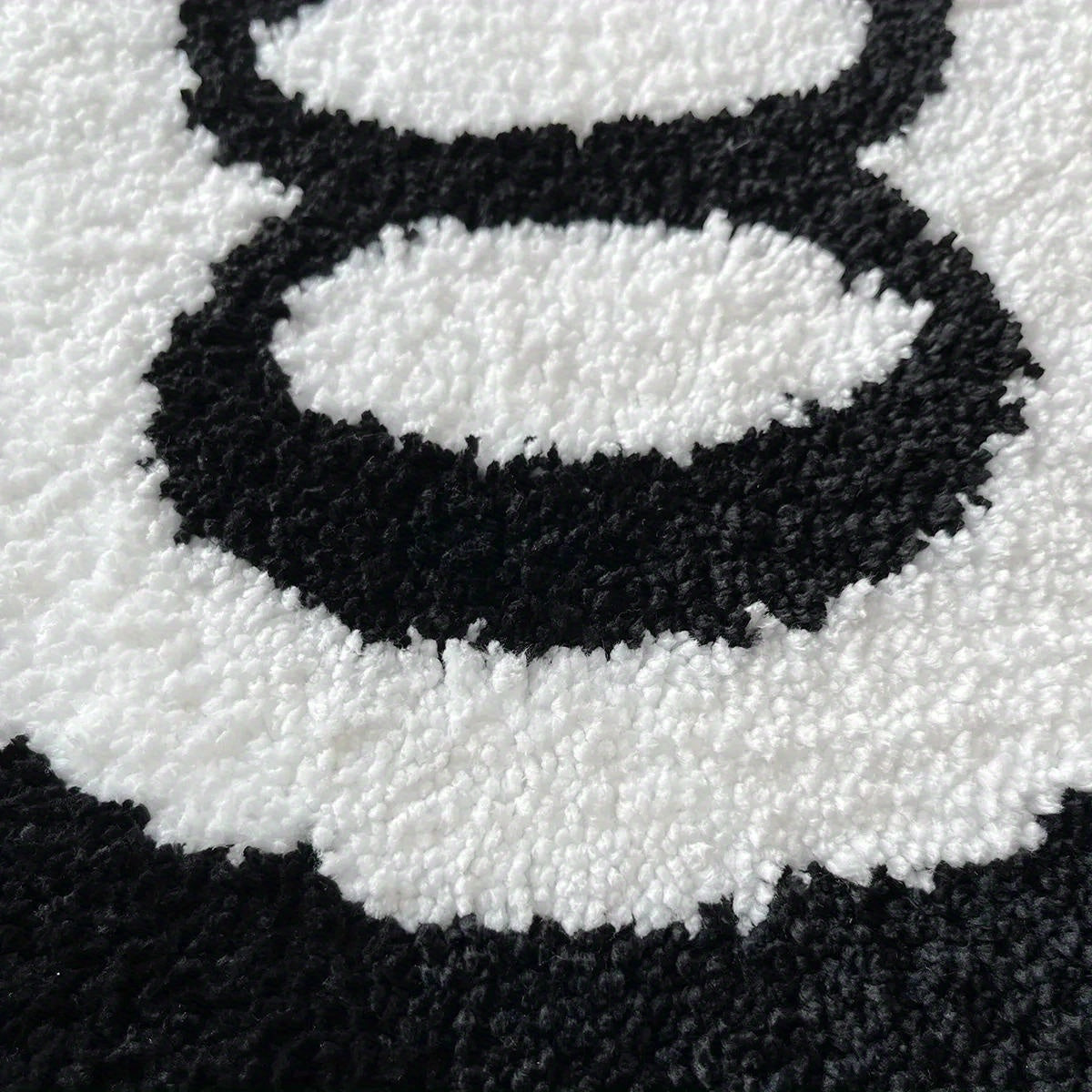 Close-up of a black and white pattern on a textured surface