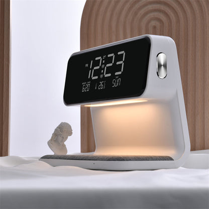 Digital clock with lamp on a bed