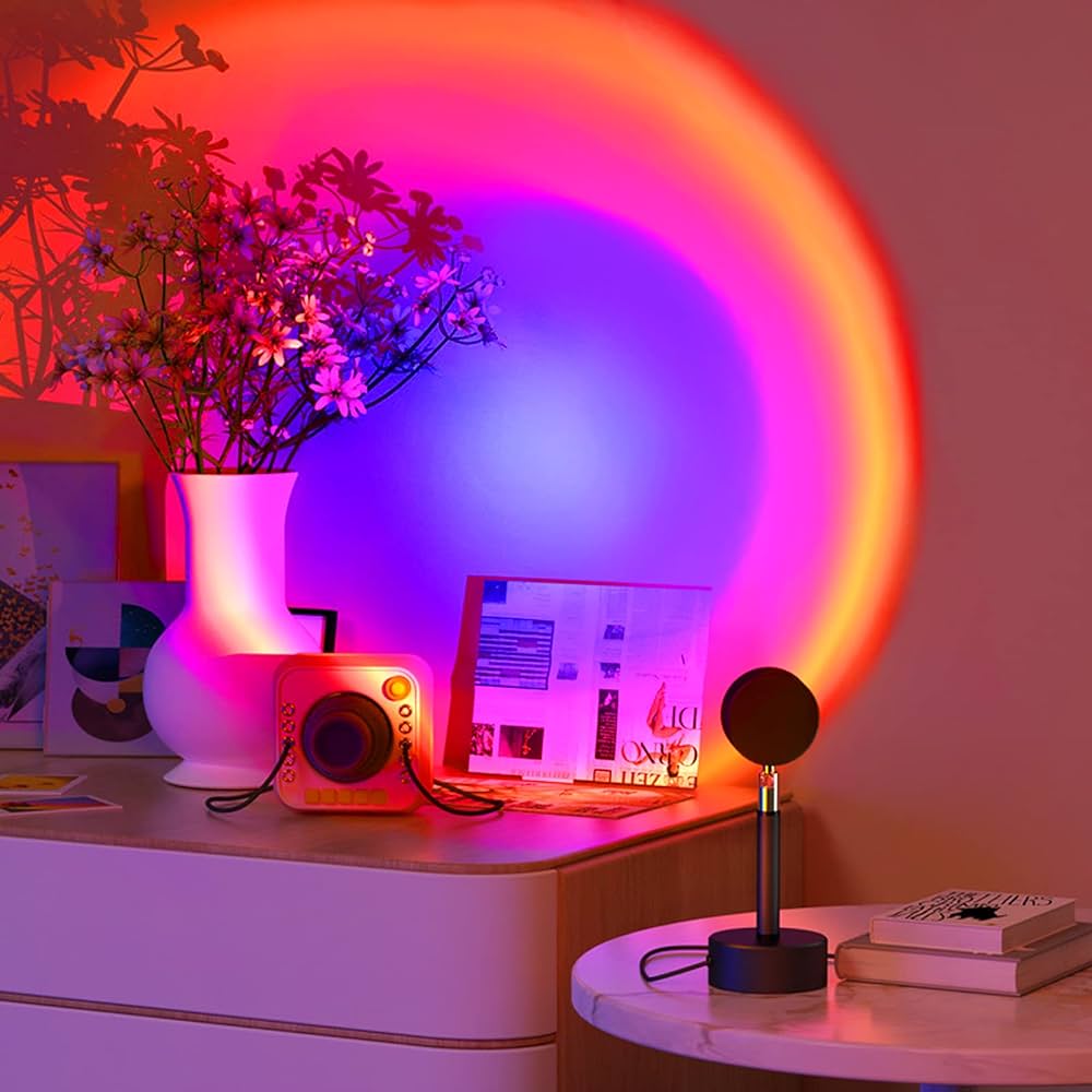 Desk setup with a laptop, camera, and microphone under colorful LED lights