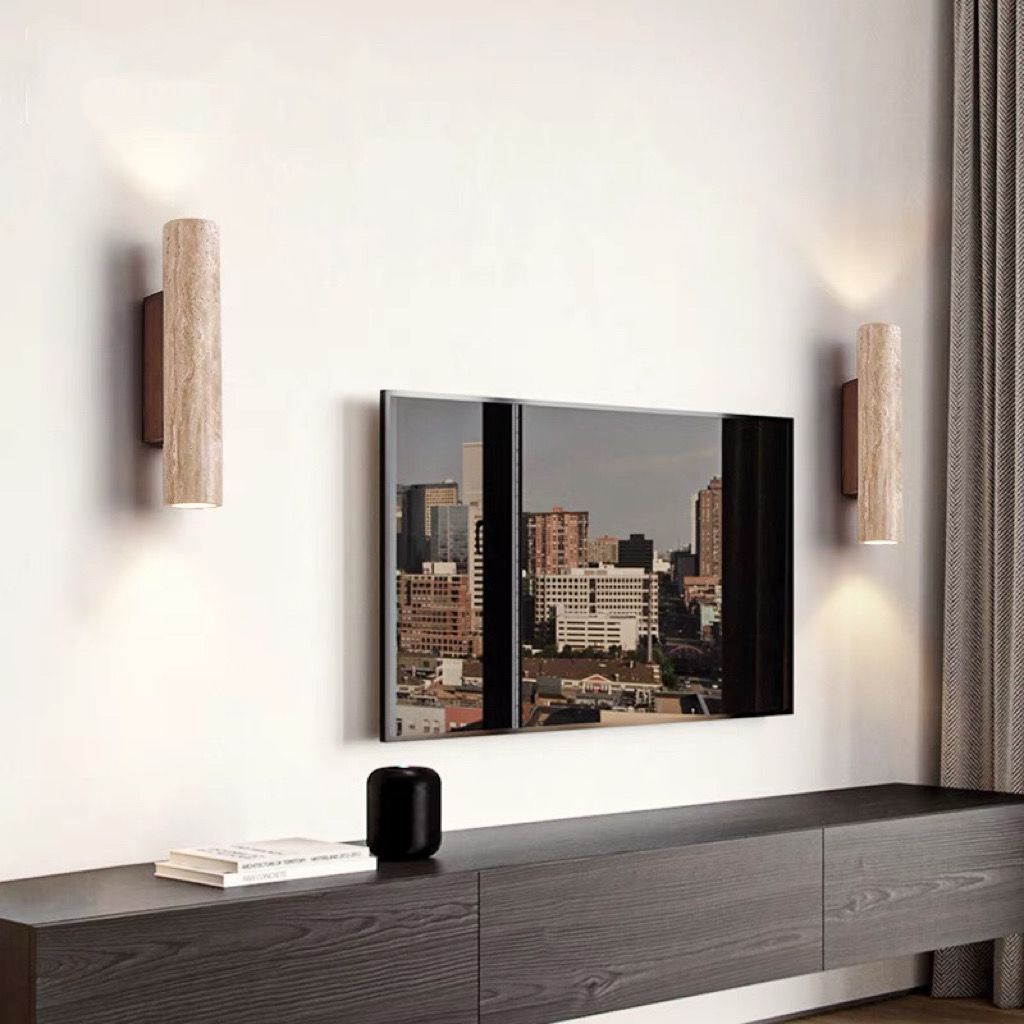 Modern living room with a TV mounted on the wall, wooden cabinet, and decorative items.