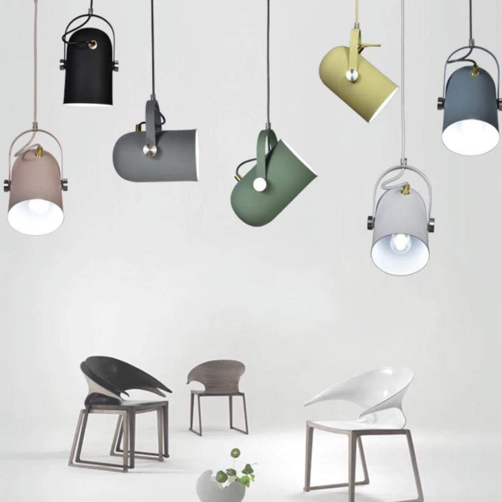 Various pendant lights hanging above chairs on a white background