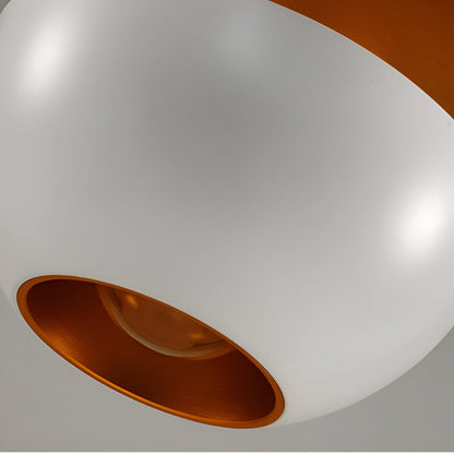 Close-up of a white light fixture with a copper interior