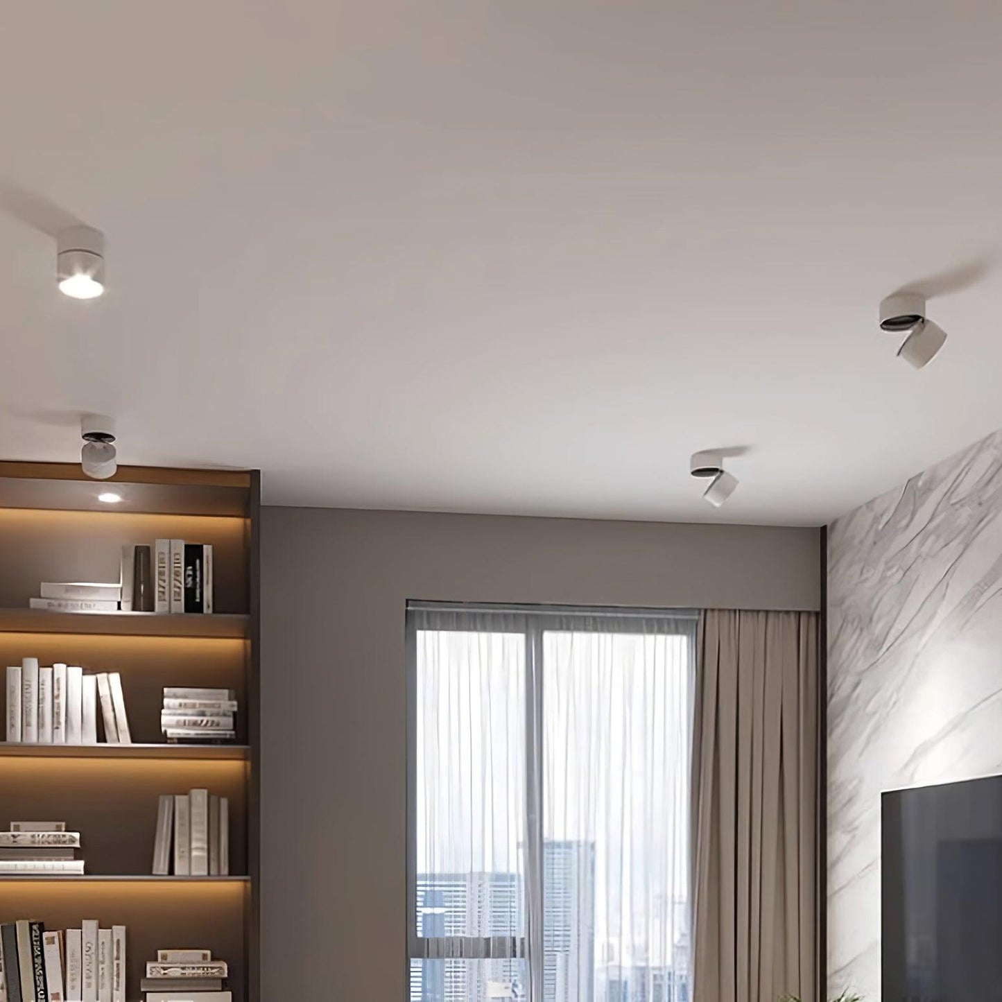Modern living room with bookshelf, window, and ceiling lights.