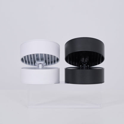 Two cylindrical light, one white and one black, on a light gray background.