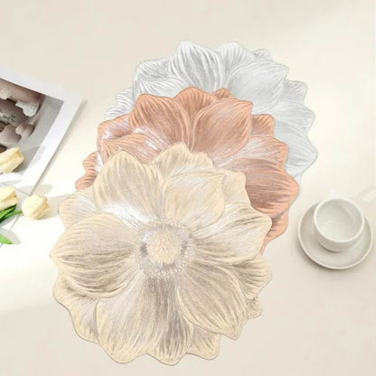Floral-patterned placemats on a table with a cup and saucer in the background.