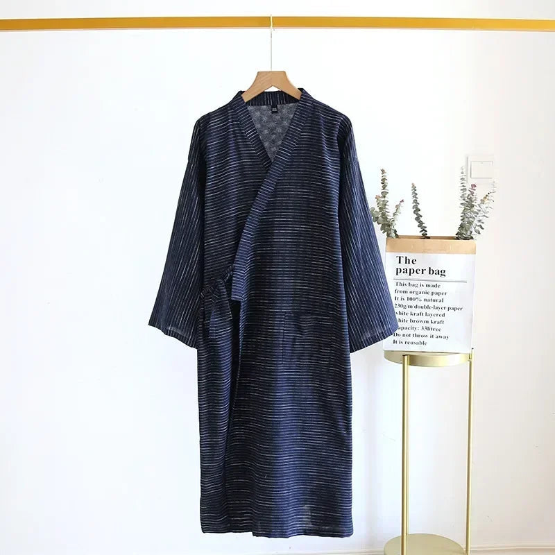 Blue striped dress hanging on a hanger against a white background