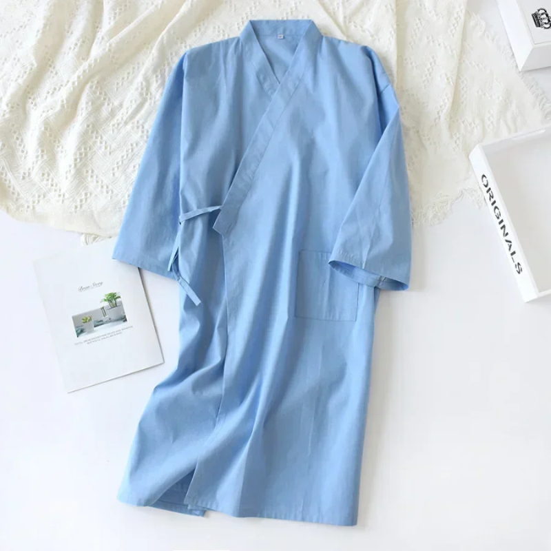 Light blue robe on a textured white surface with a magazine underneath
