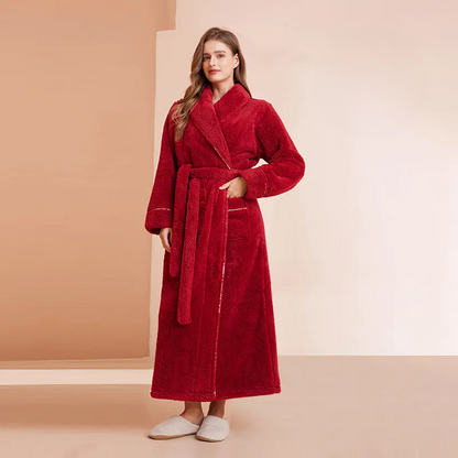 Woman wearing a red robe against a beige background