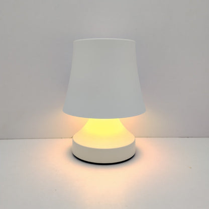 Small table lamp with a white shade and base on a light gray background