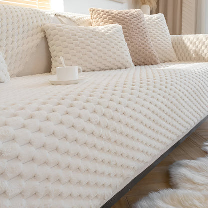 Beige textured sofa cover on a couch with pillows in a living room setting.