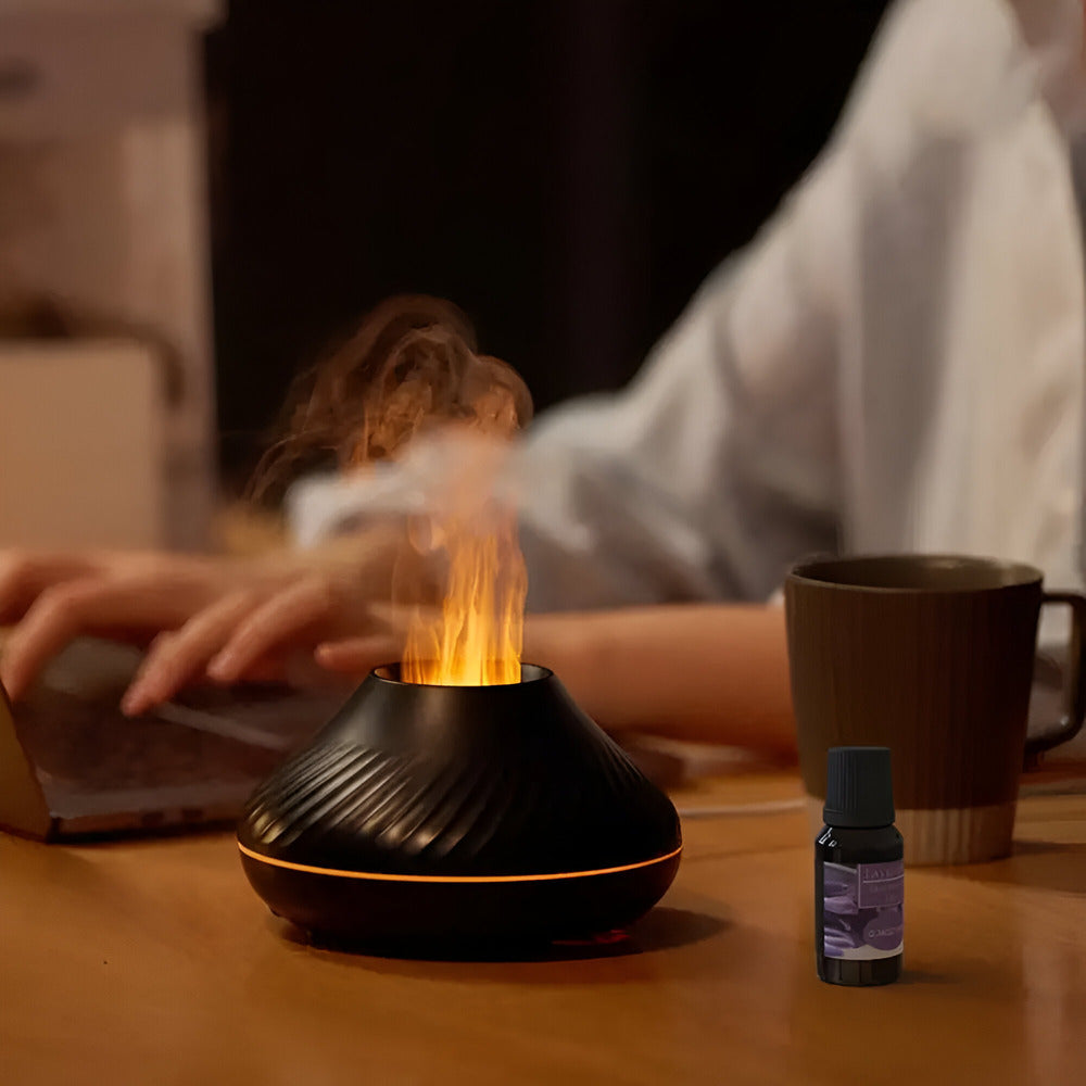 Black lava lamp on a table with a person using a laptop in the background