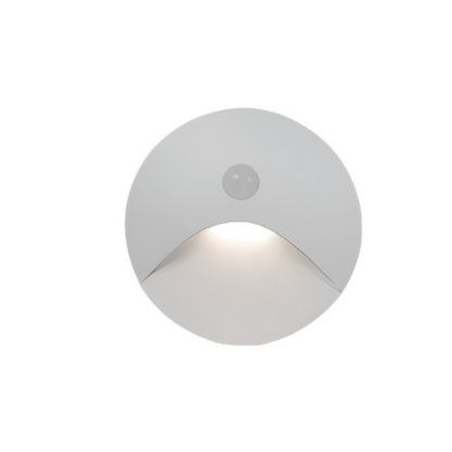 Round white outdoor light fixture on a white background