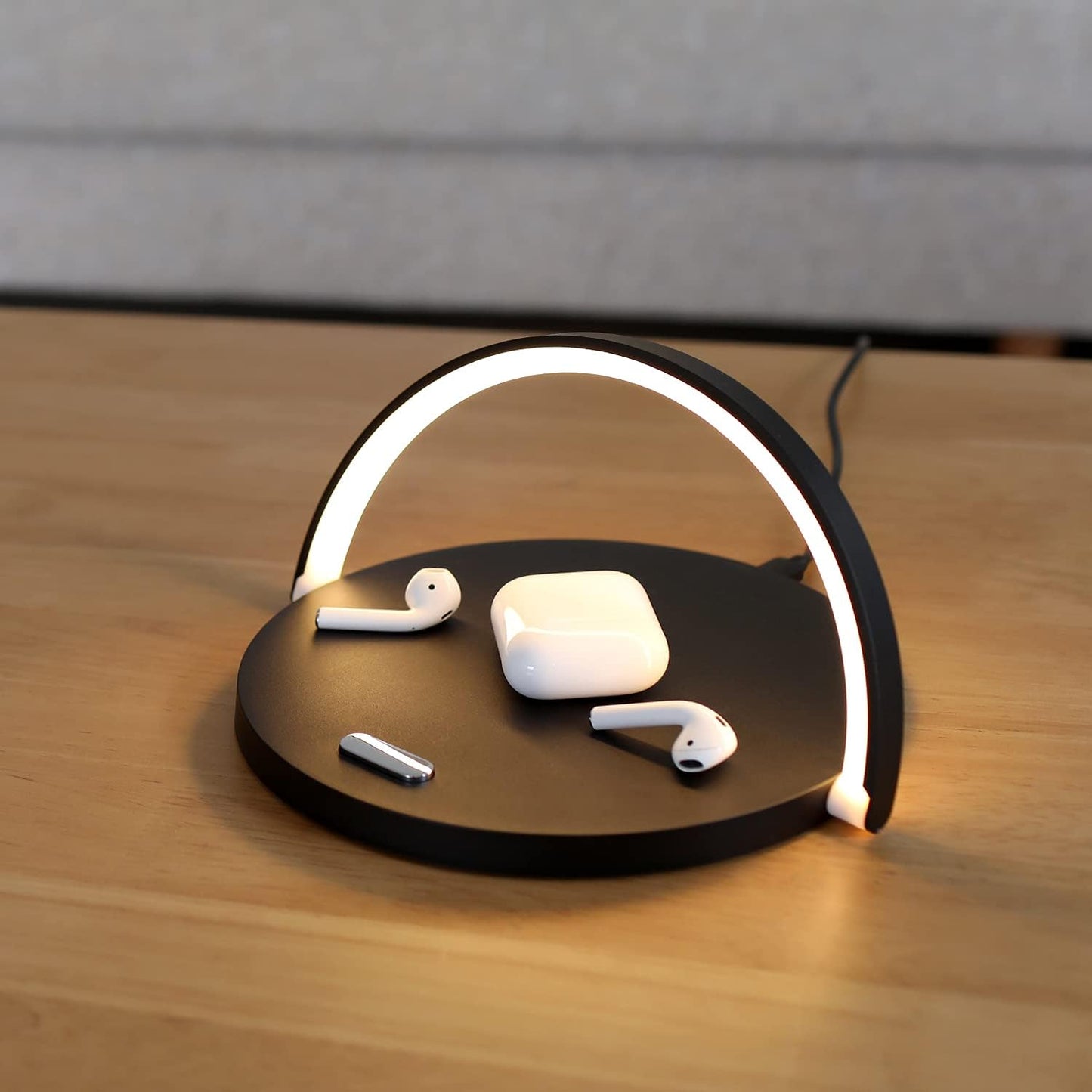 Wireless charging pad with AirPods on a wooden surface
