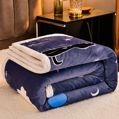 Folded blue blanket with cartoon designs on a bed