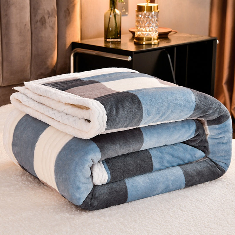 Stack of folded checkered blankets on a bed in a bedroom setting.