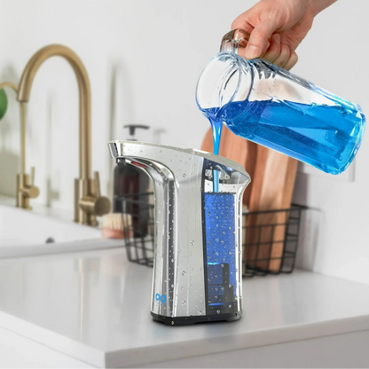Hand pouring blue liquid from a bottle into a silver soap dispenser with text 'Easy Refill 500ml Capacity' on a kitchen counter.