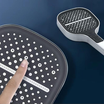 Black and white paddle with finger pointing at it on a dark blue background