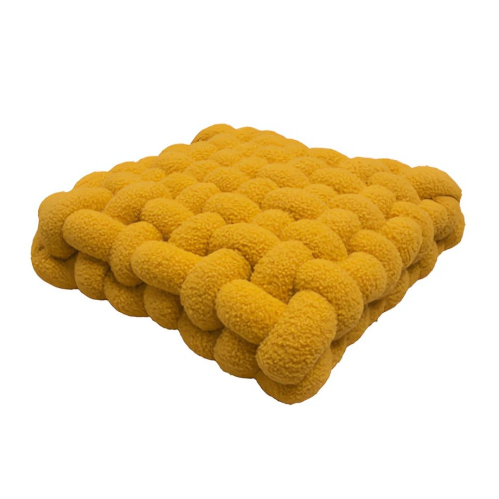 Yellow textured cushion on a white background