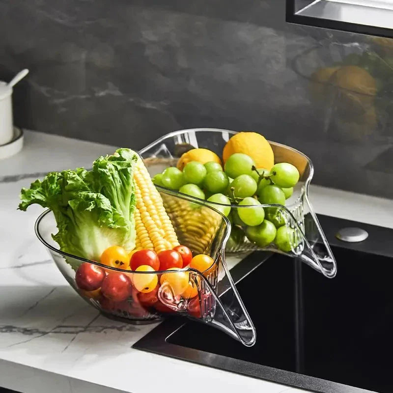 Clear kitchen fruit and vegetable divider with fruits and vegetables on a countertop.